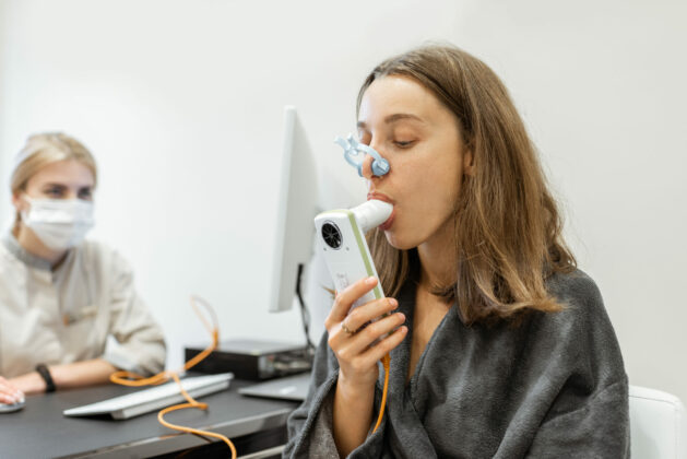 Young,Woman,With,Doctor,During,A,Spirography,Test,,Measuring,Breathing